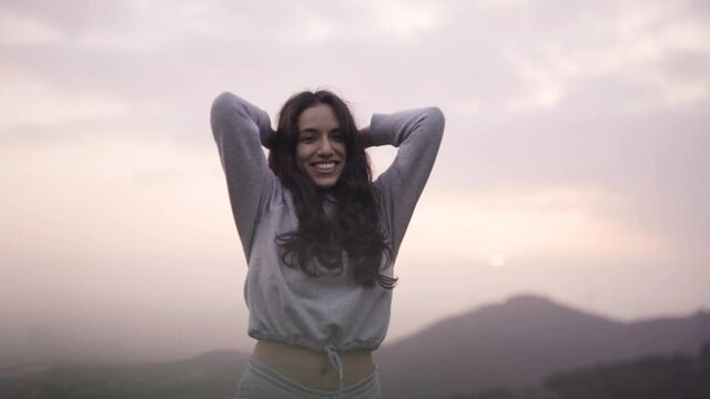 Mixed race woman enjoying at sunset