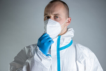 Doctor in protective suit mask getting dress up to suit againts rapidly spreading coronavirus 2021...