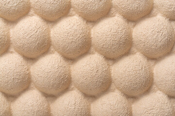 Cardboard texture with repeated round bumps. Close up.