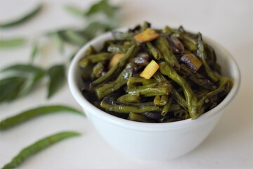 Stir fried beans with chopped coconut, green chillies, turmeric and curry leaves using coconut oil. An ingradient of Kerala meal