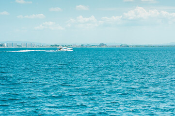 White sea boat rushes on the sea, against the background of the resort area of the Black Sea coast. High quality photo