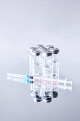 VACCINE ampoules and syringe  isolated on a reflecting surface. Vaccination. 