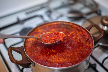 red borscht in a saucepan on the stove, Ukrainian cuisine dish, home cooking, simple homemade food