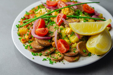 Haricot tomato bean sauce with turmeric potatoes, pork and herb sausage, and scrambled egg