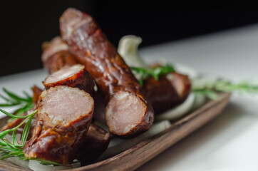 Traditional Polish juniper sausage on a wooden plate, luxury smoked product