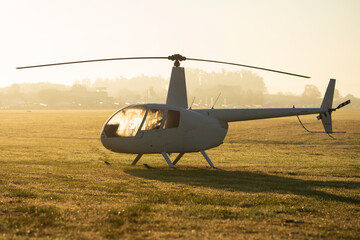 A light helicopter on a grass landing area