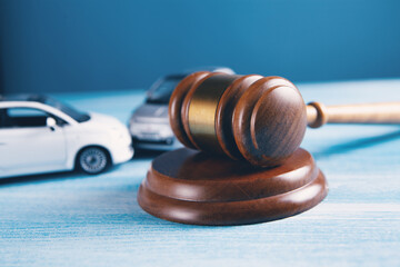 Model of car and gavel. Accident lawsuit or insurance, court case.