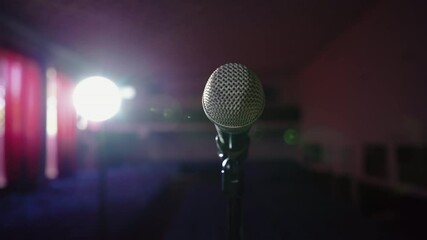 Microphone in bright light. An empty hall without spectators. Concert hall scene. Waiting for the performance of an artist, singer, politician. World crisis, financial losses	