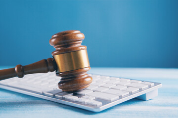 Close up view of a hammer and a computer keyboard.