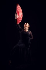 flamenco woman with black dress and red fan looking up - obrazy, fototapety, plakaty
