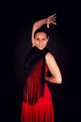 flamenco woman in red skirt and one hand up