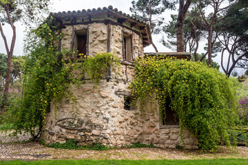 Fototapeta na wymiar Labrador's house within the Park in Alameda de Osuna. Cottage. Wooden house in the field. Parks and gardens of Madrid