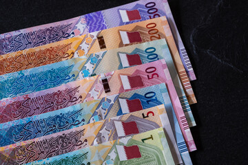 New Qatari Riyal banknotes on black background