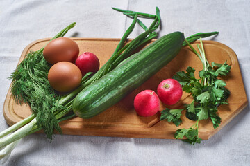 cucumber eggs onion parsley dill for making salad on a wooden stand selective focus