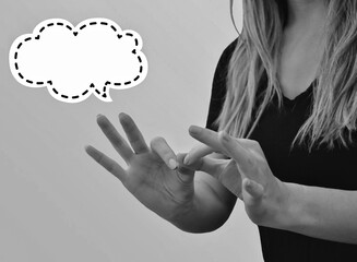 Interpreter signing in black and white with speech bubble
