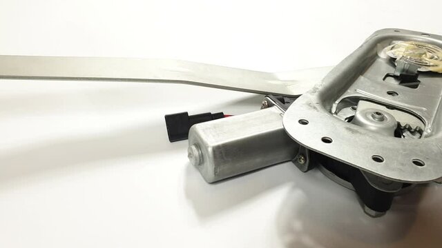 car spare parts, car window lifter, iron and plastic parts on white background