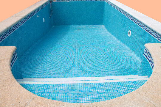 Isolated empty swimming pool with blue tiles