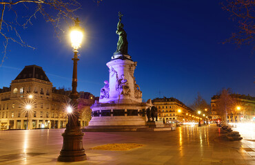 Fototapeta na wymiar Monument to the republic at night . It is bronze statue of Marianne, a personification of the French republic at the Place de Republique in Paris.