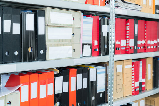 Colourful Blank Blind Folders With Files In The Shelf. Archival, Stacks Of Documents At The Office Or Library. Physical Document Storage Units