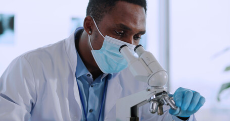 Fototapeta premium Afro-americcan young biologist doctor examining bacteria in medical office laboratory taking samples. Vaccination development.