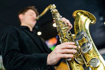 Fototapeta na wymiar Male jazz musician playing a saxophone in a restaurant