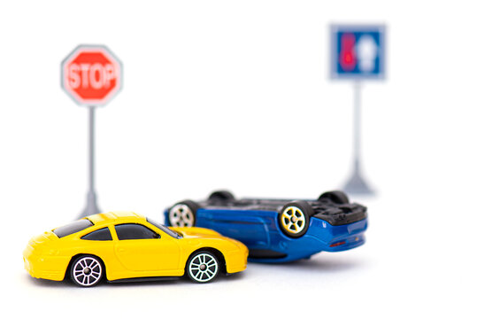 MOSCOW - MAR 31: Accident with two toy cars and sign stop isolated on white. Concept picture about accident on the road in Moscow, March 31. 2021 in Russia