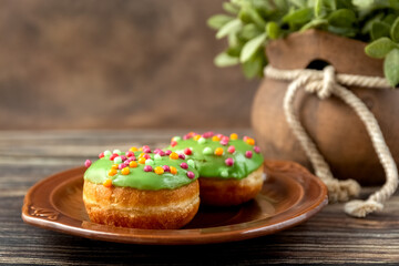 Bun, donut covered with glaze. Tutti frutti bun on a plate. Sweet pastries. Dessert. Copy space. CPlace for your text. lose-up. High quality photo
