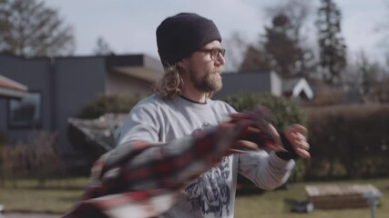 Carpenter Removing Shirt To Start Working Outdoors