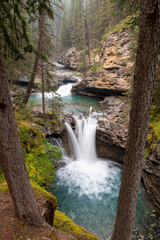 Fototapeta premium Long exposure shot of a waterfall in a canyon