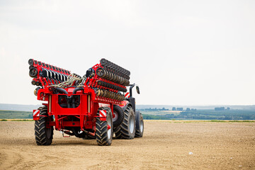 Large modern tractor for preparing the field after winter for sowing grain. Agricultural machinery