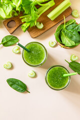 Vegan smoothie recipe. Healthy diet and nutrition, vegan and alkaline drink. Green fresh smoothie with celery and spinach on a pink background. Top view. Flat lay. Copy space.