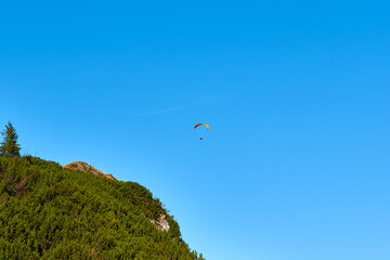 Paraglider flying over the Mountains.