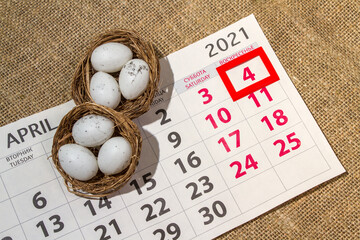 Calendar and nest with eggs lies on sacking, 4 april easter holiday