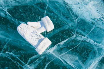 Fototapeta na wymiar Mittens on the icy surface of Lake Baikal