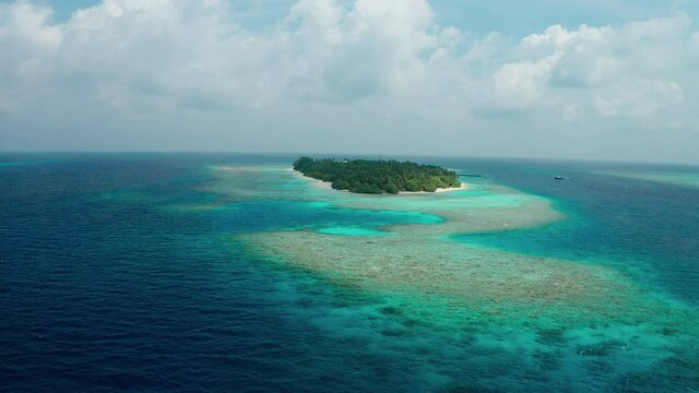 Aerial view of a tropical island in the Indian Ocean. Thinadhoo (Vaavu Atoll), Maldives
