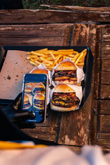 taking a photo of hamburgers and fries