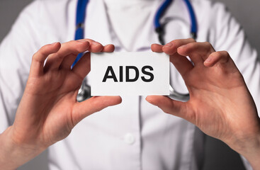AIDS acronym word inscription in doctor hands