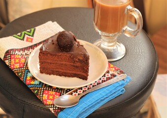 delicious chocolate cake on a plate with coffee with milk
