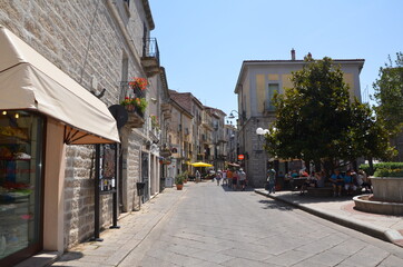 A small street in an old European summer town. The old city in the rays of the summer sun. Walk through the old town. An interesting journey.