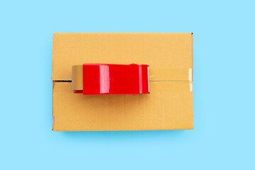 Packaging tape dispenser on cardboard box