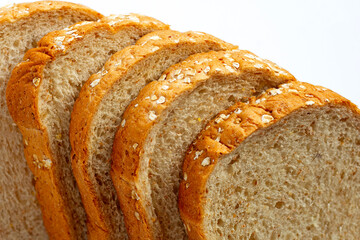 Sliced whole wheat bread on white background.