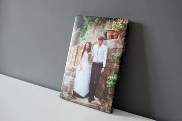 Canvas print wedding photography on white table and grey wall background