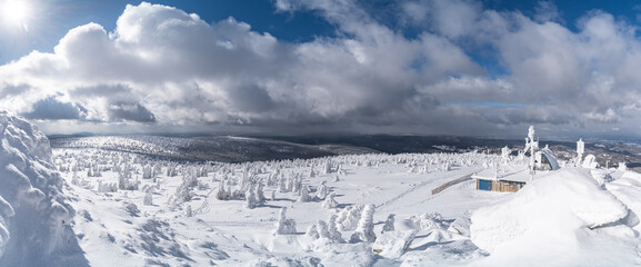 Winter mountain landscape, Poland, Panorama of the Giant Mountains in sunny winter day, from Biała Dolina in Szklarska Poreba on Szrenica and Sniezne Kotly, blue sky, white and dark clouds. Snow cover © Marcin