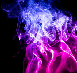 Naklejka premium Colored smoke on black background