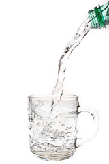 Water poured from a bottle into a glass. Quenching thirst with drinking water.