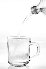 Water poured from a bottle into a glass. Quenching thirst with drinking water.