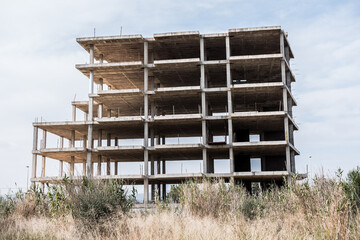 Unfinished residence overall shot. Abandoned project due to the crisis. Concrete foundations remaining.