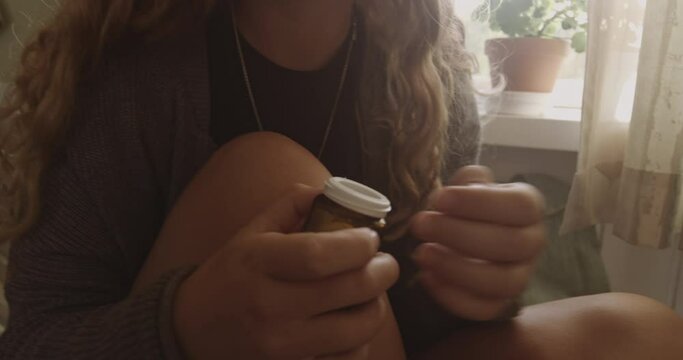 Woman Swallowing Pills From Bottle To Overdose