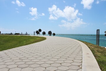 Empty bicycle path on a hill along the ocean coast with beach views. Outdoor sports. Pedestrian path.