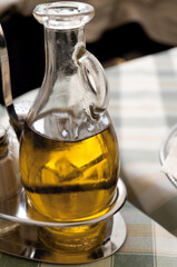 A jug of olive oil at a table